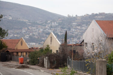 METULA, ISRAEL - DECEMBER 4: Houses which were damaged by Hezbollah rocket strikes are seen in the northern town with the Lebanese village of Al Adisa seen In the background on 4 בדצמבר 2024 in Metula, Israel. Ten people were killed in Israeli airstrikes in Southern Lebanon overnight and Hezbollah had earlier fired two mortars at an Israeli army base, but the US and France have said the ceasefire is largely holding despite the violence. (Photo by Amir Levy/Getty Images)