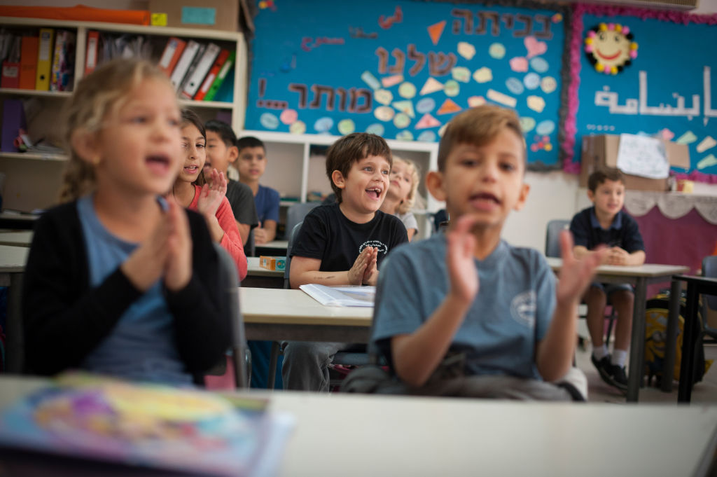 KAFR QARA, ISRAEL--OCTOBER 15: Lessons are taught simultaneously in Hebrew and Arabic to both Jewish and Arab Israeli children at the Wadi Ara Hand in Hand School on October 15, 2016 in Kafr Quara, Haifa District of Israel. The Hand in Hand educational School concept started in 1997 by Amin Khalaf, an Arab teacher and lecturer, and Lee Gordon, a Jewish-American social activist, after they met while working in their respective fields promoting Arab-Jewish dialogue in Israel. The schools they pioneered host an equal number of Jewish and Arab students respectively. Two teachers speak simultaneously in both Arabic and Hebrew while teaching the lesson. Judaism, Islam and also Christianity are taught with equal weight to all students, and each faith's respective religious holidays are also observed. Emphasis is given not only to one's own culture and language but also to those of the "other". The children study two accounts of history: the creation of the "Jewish homeland" as well as the narrative of the Palestinian struggle. (Photo by Craig Stennett/Getty Images)