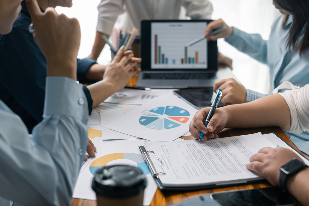Financial analyst presented a detailed data analysis graph to their colleague, corporate office, demonstrating the business's financial status and trends. Concept of business data analysis.